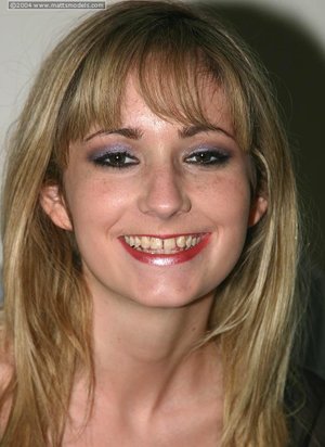 18 year old girl Katie Lewis stands naked after undressing in her bedroom